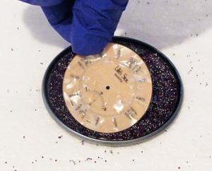 placing a watch face onto glass beads