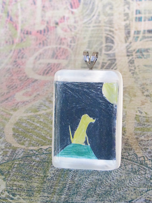 child's drawing in a jewelry pendant