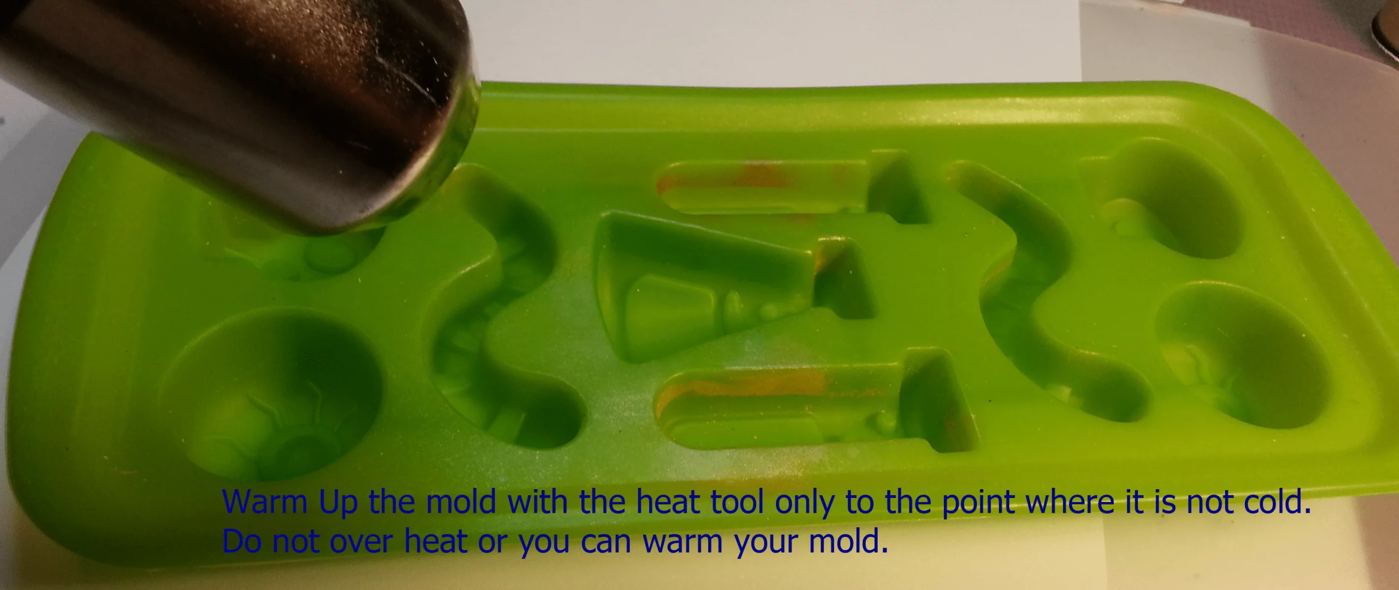 warming a resin mold with a heat gun