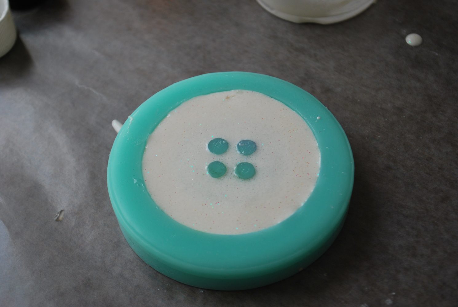 white resin in a button mold