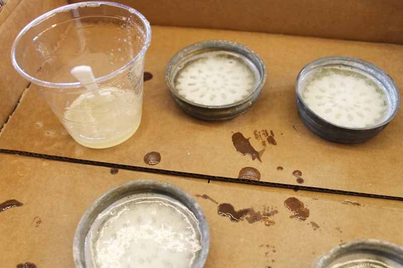 adding a second pour of resin to mason jar lids