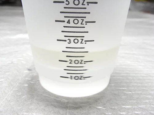 measuring resin in a cup