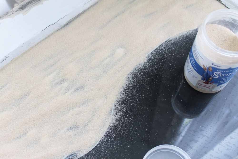 sand applied to glue on a window pane