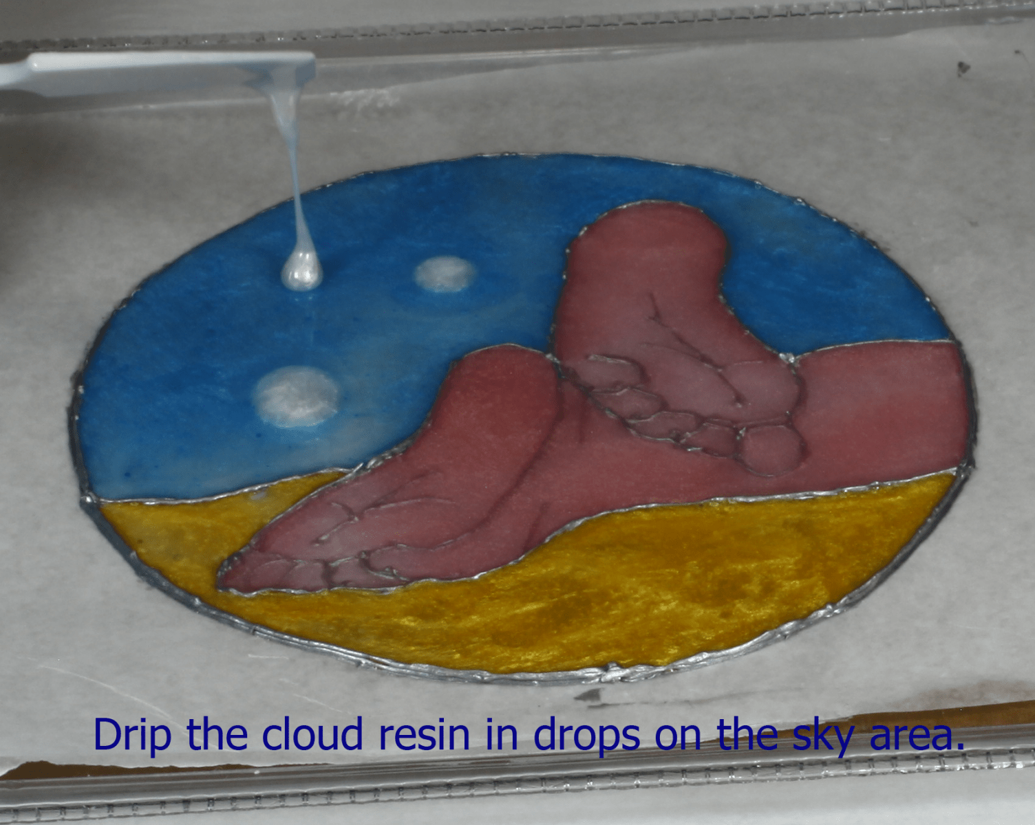 dripping white resin to create clouds