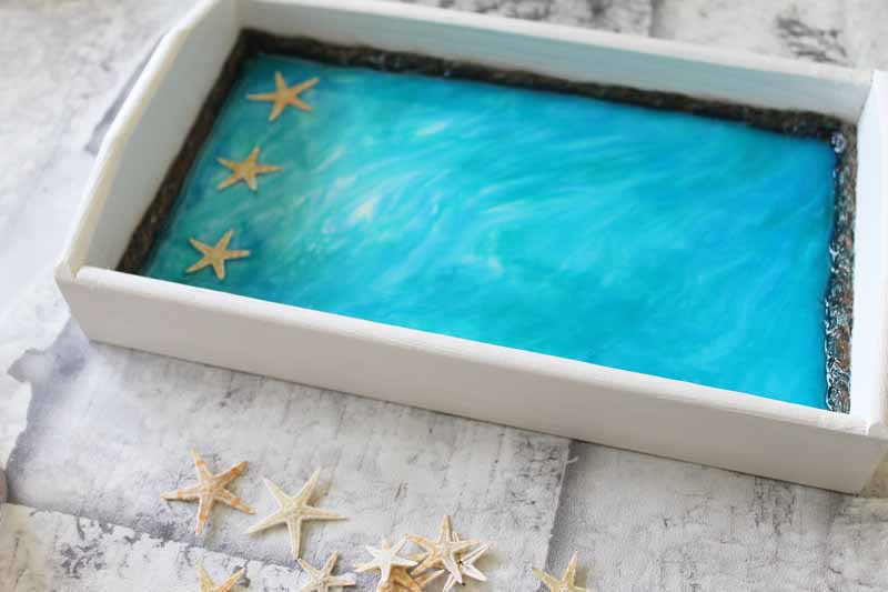 adding starfish to a resin tray