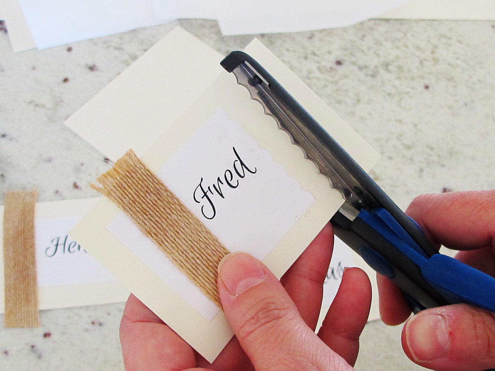 trimming edge of a place card with decorative scissors