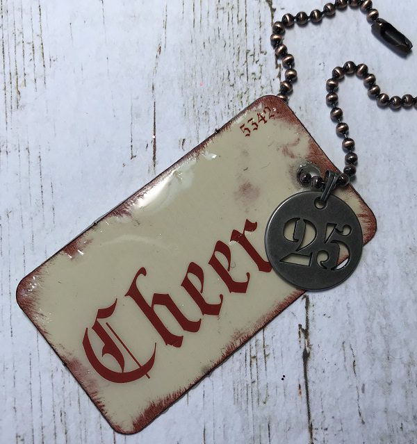 tag 5 - Flashcard by Tim Holtz with distressed edges, charm, and chain
