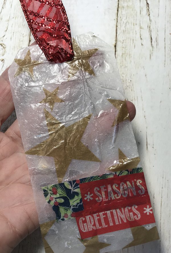 tag 2 - star tissue paper turns translucent with resin coating, washi tape adds detail