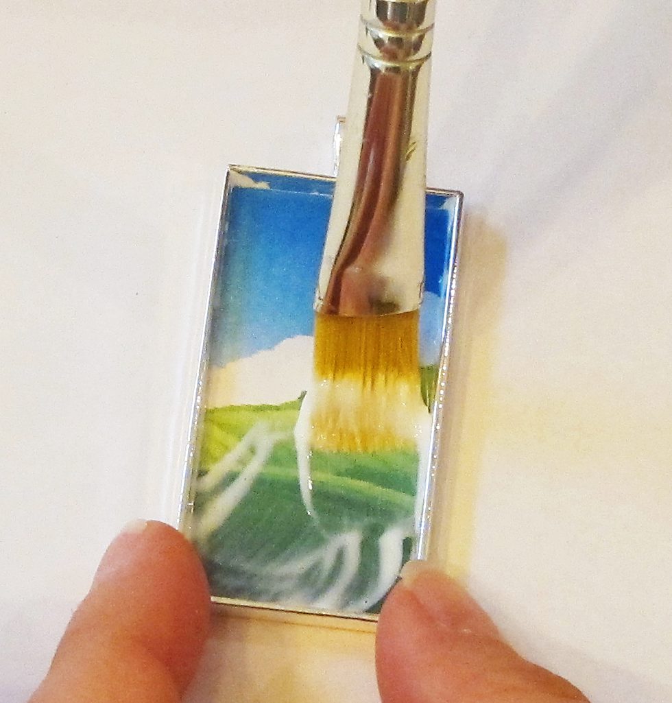 adding glue to a clip art within a pendant