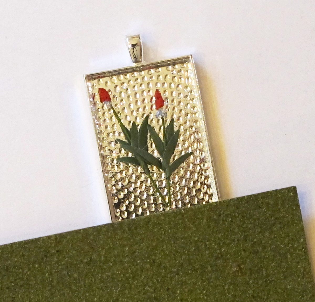 miniature flowers and grass in pendant