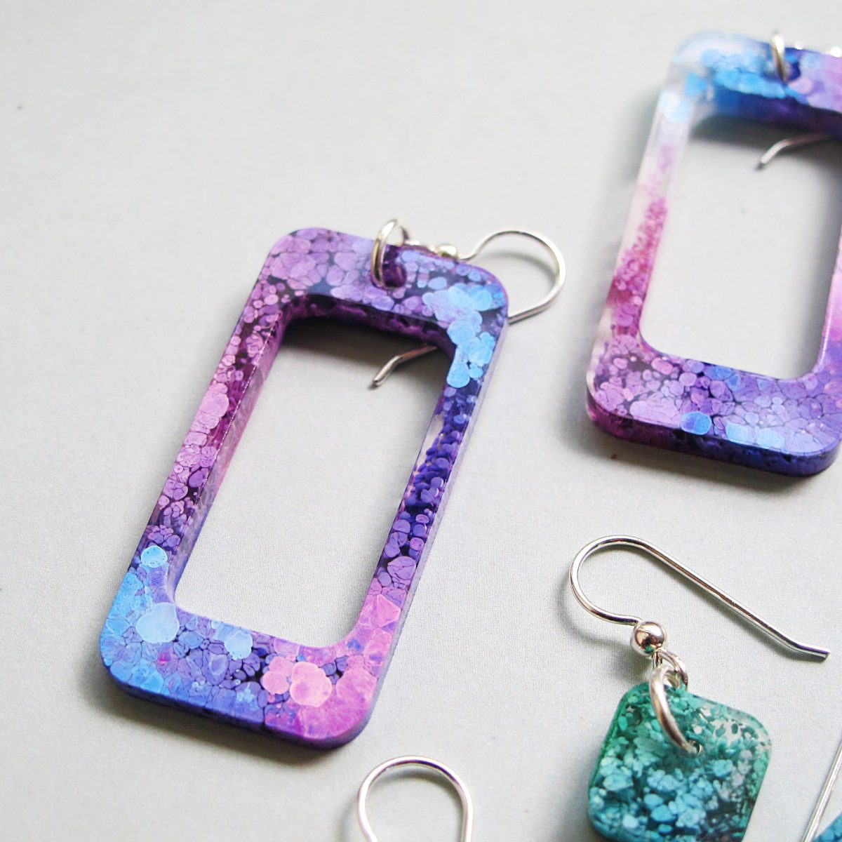 green purple and blue resin petri earrings