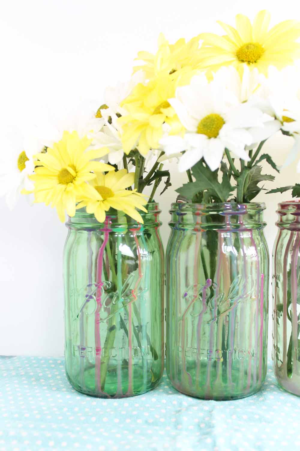 finished resin mason jar project with flowers in jars