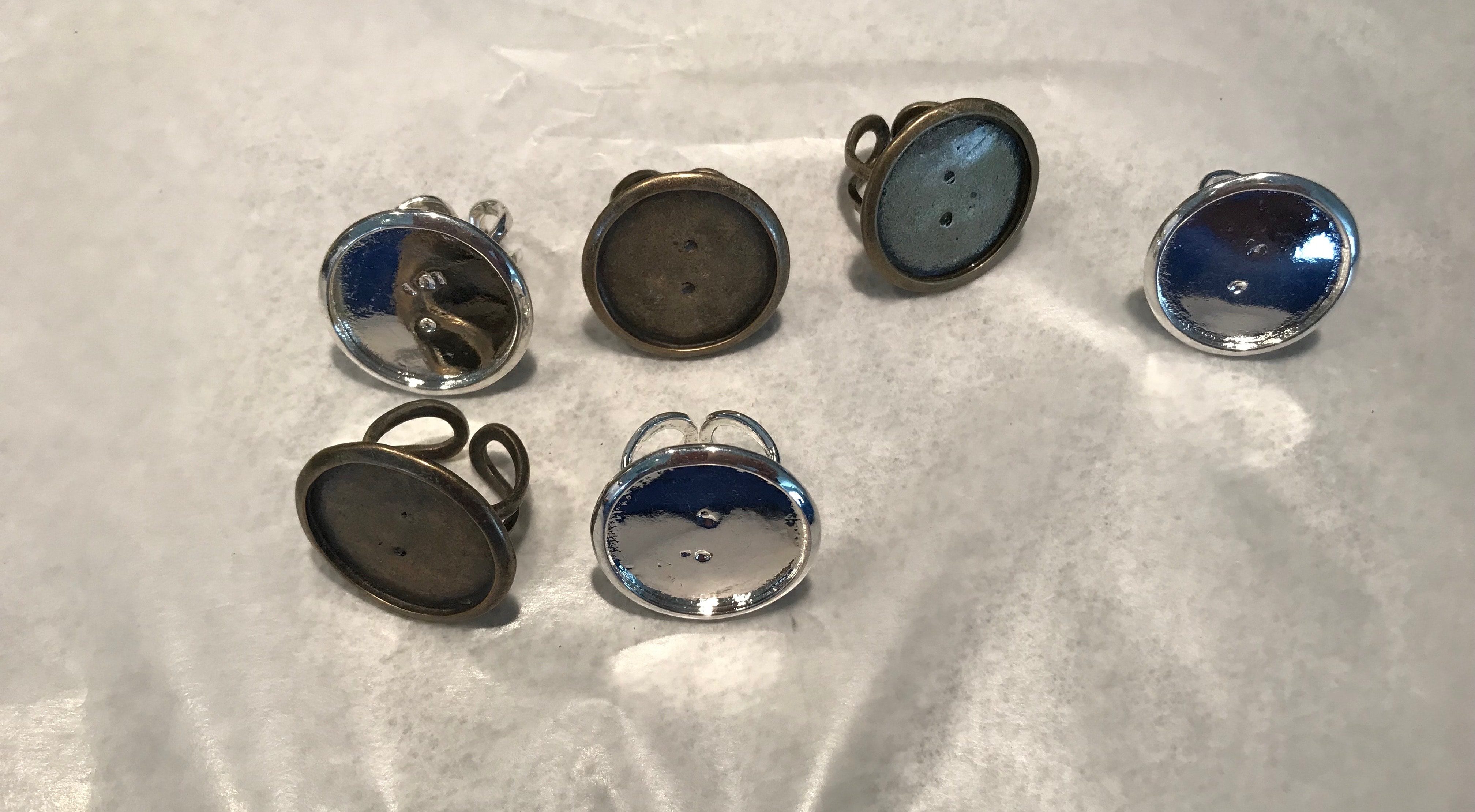 Three silver-tone and three antiqued brass-tone empty rings