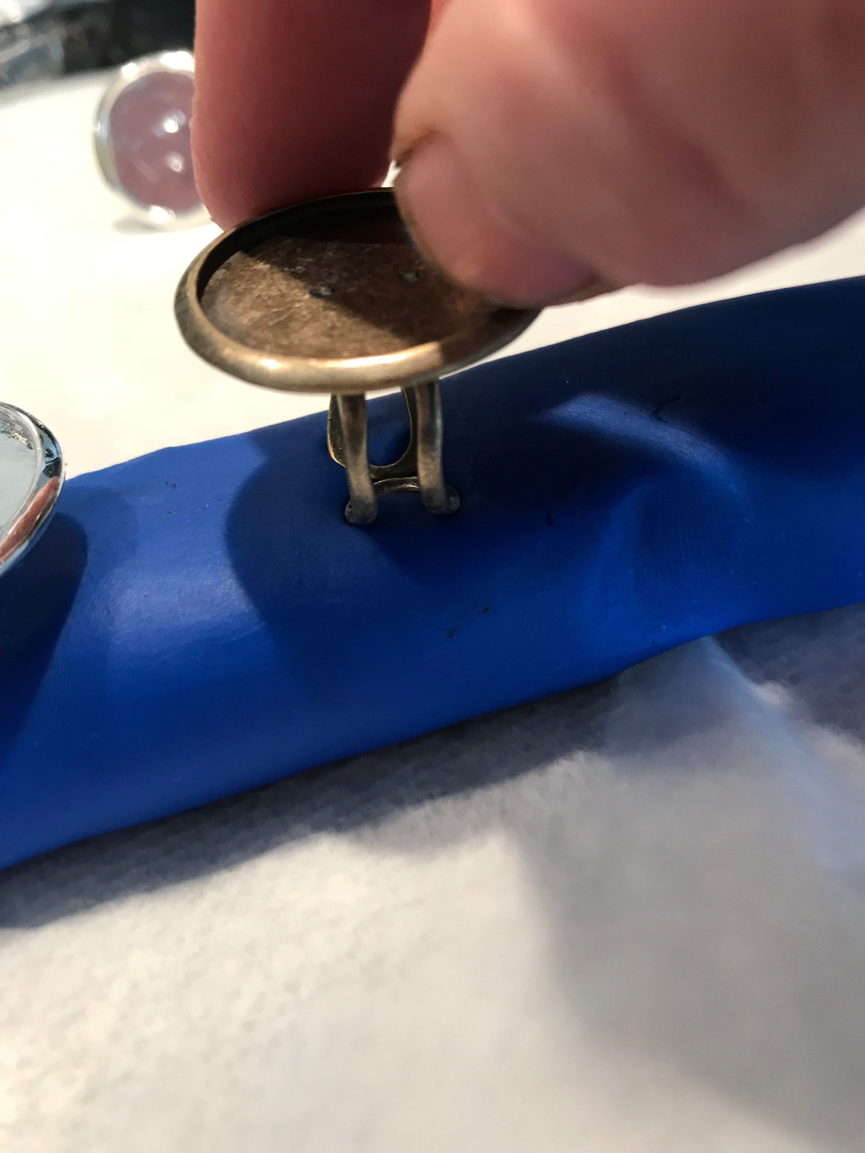 Placing ring in blue Play-Doh for stability