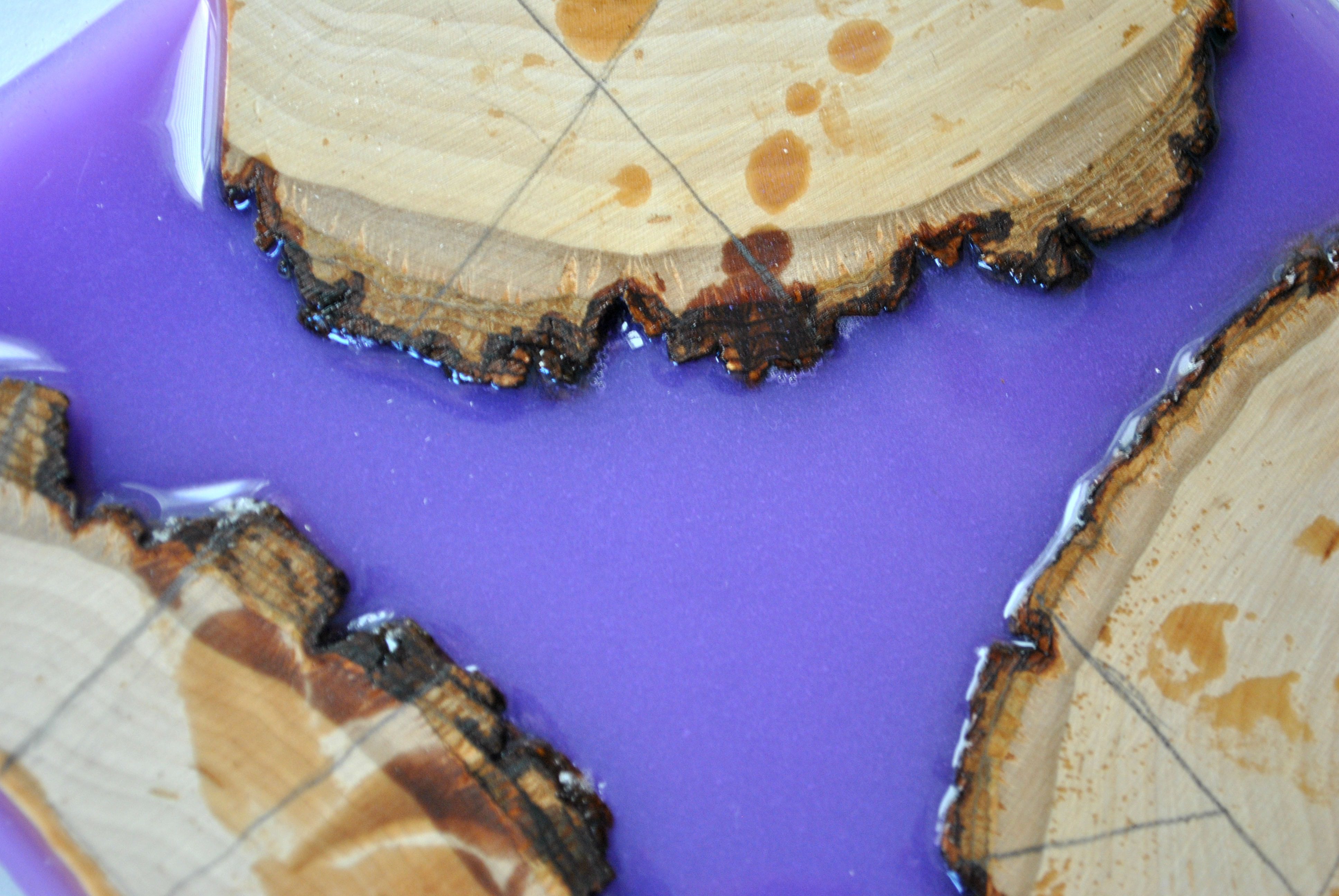 pieces of wood in lavender resin with cut measurements drawn in pencil