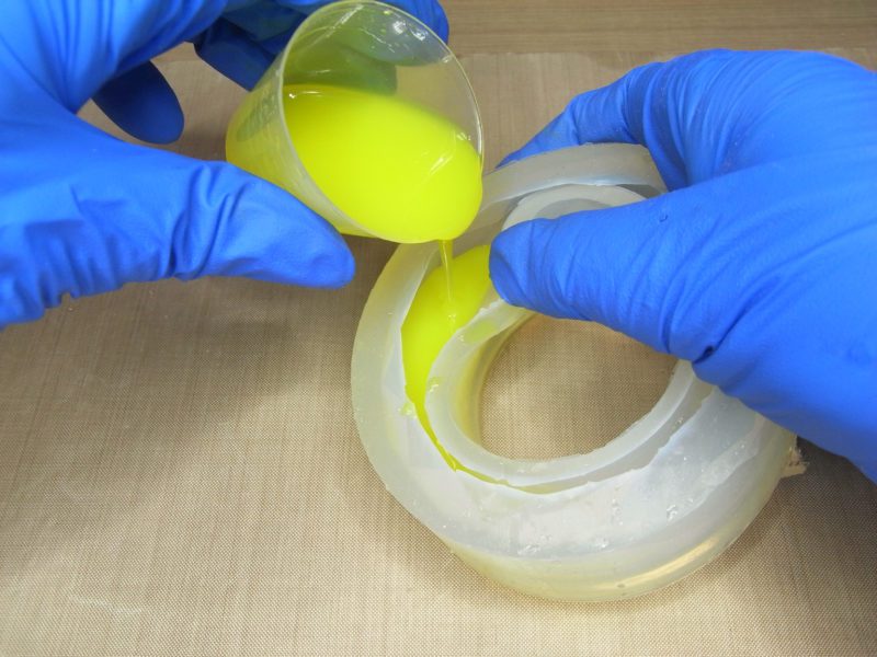 pouring resin into a bracelet mold