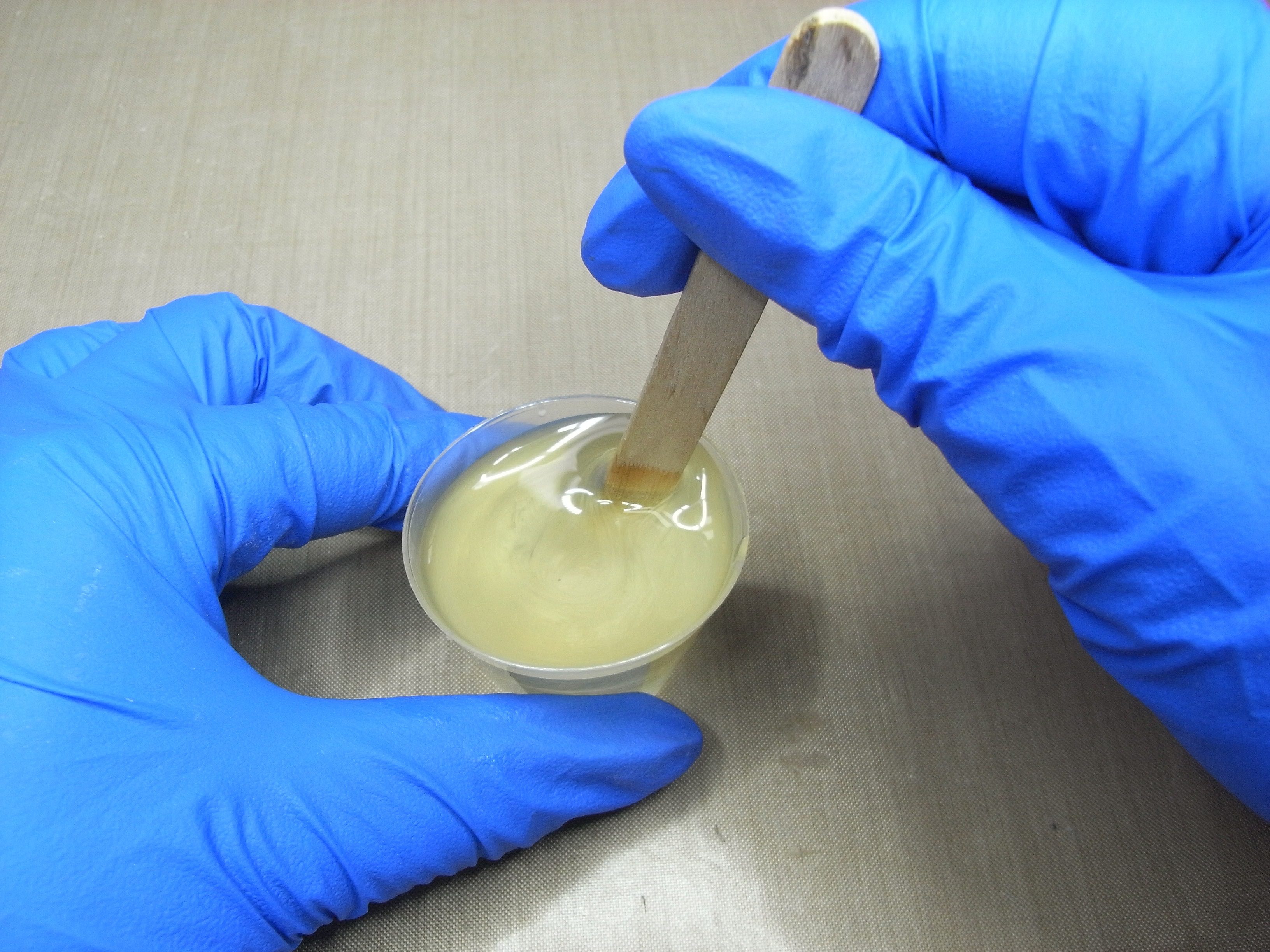resin mix stirred with wooden stirrer