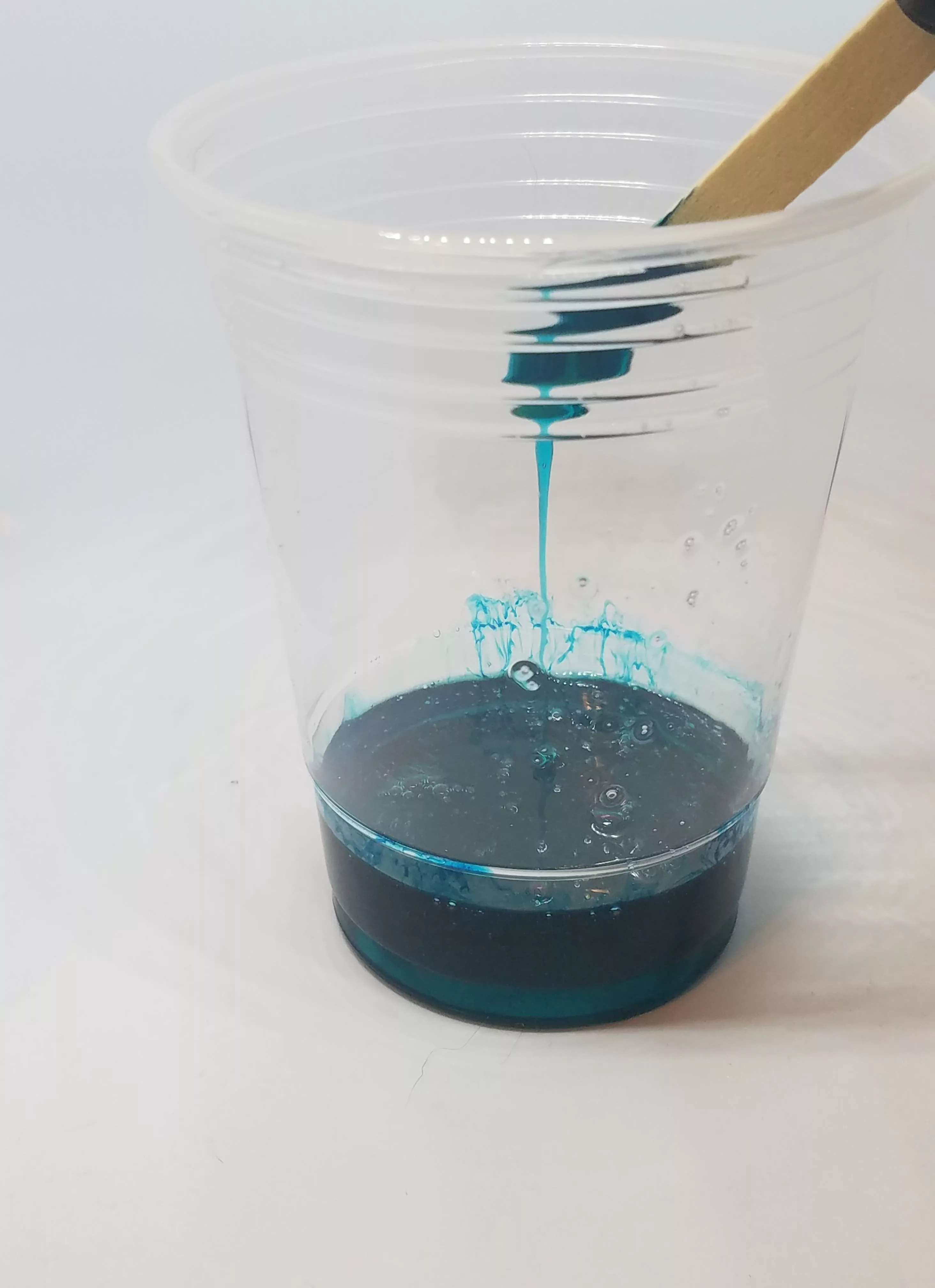mixing resin with wooden stirrer
