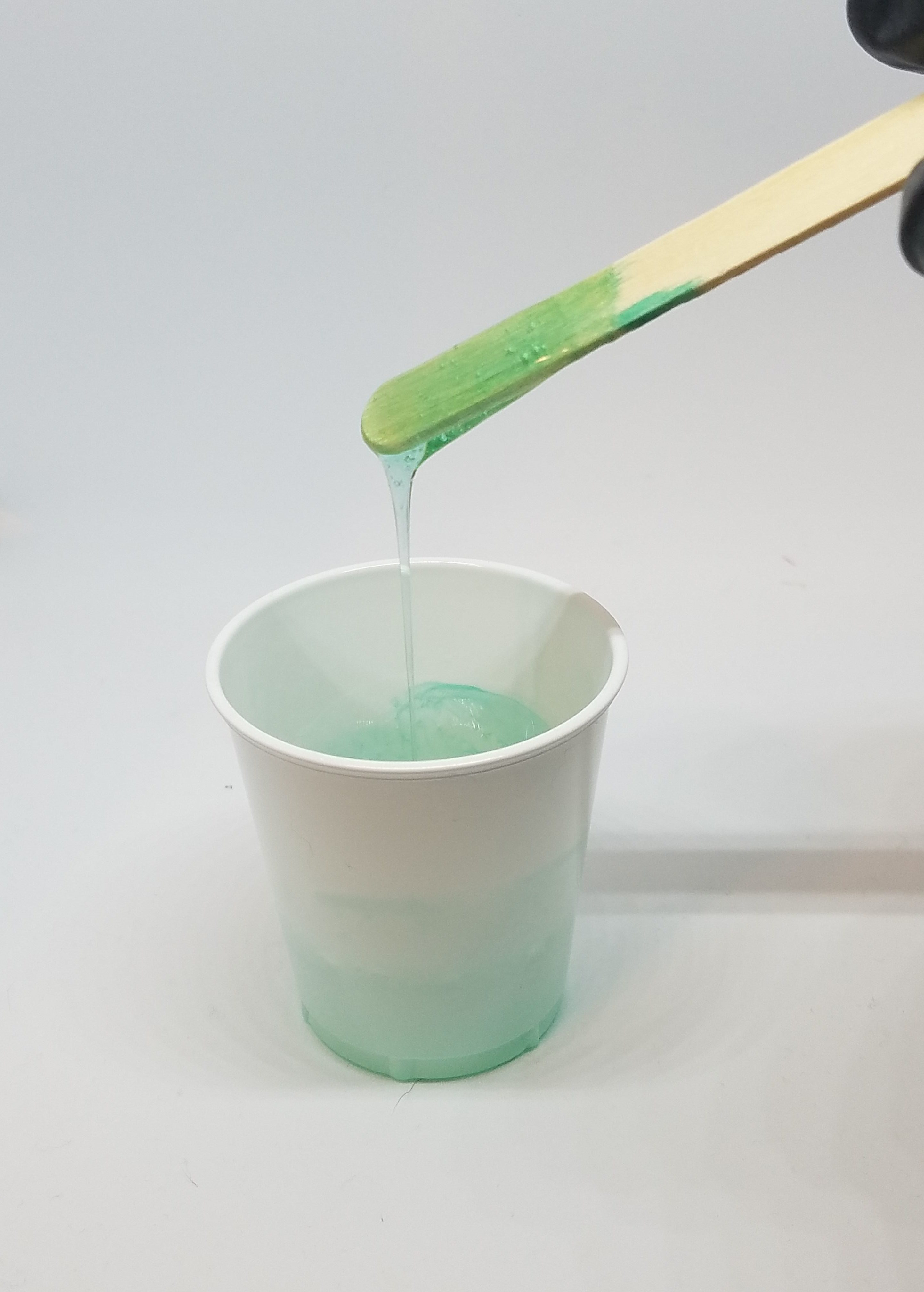 mixing resin with wooden stirrer