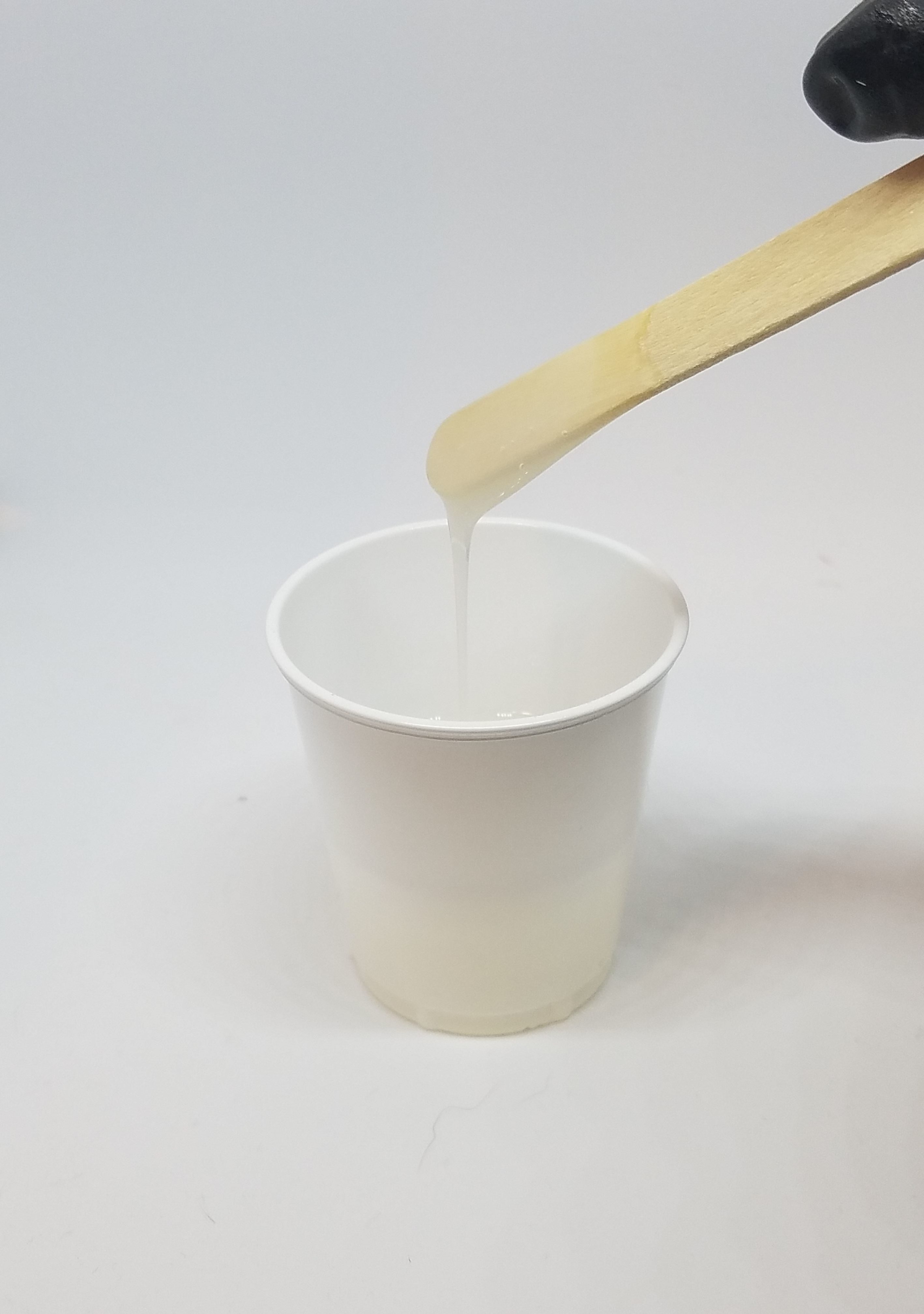 mixing resin with wooden stirrer