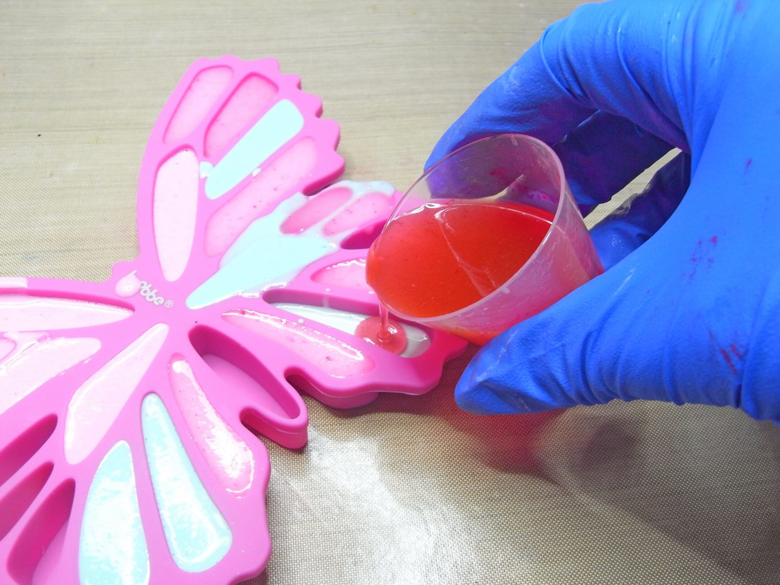 adding resin to a silicone mold