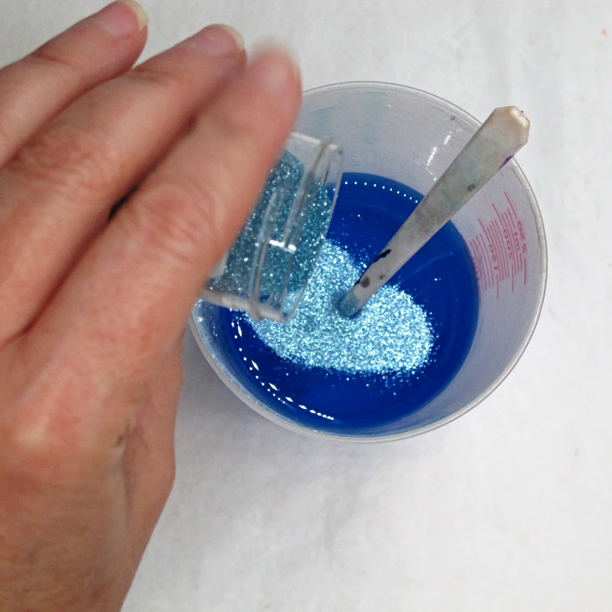 adding glitter to transparent blue resin