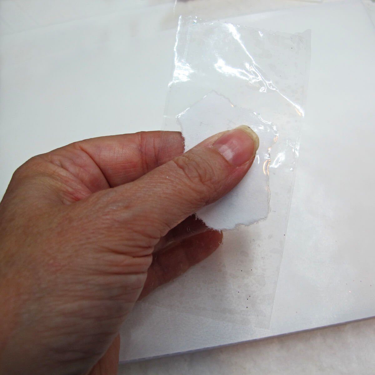 placing paper onto clear packing tape