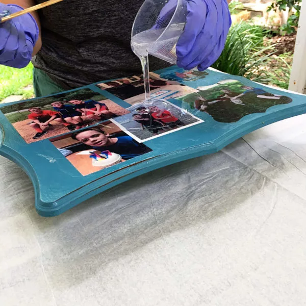 pouring resin onto a mothers day diy gift photo board