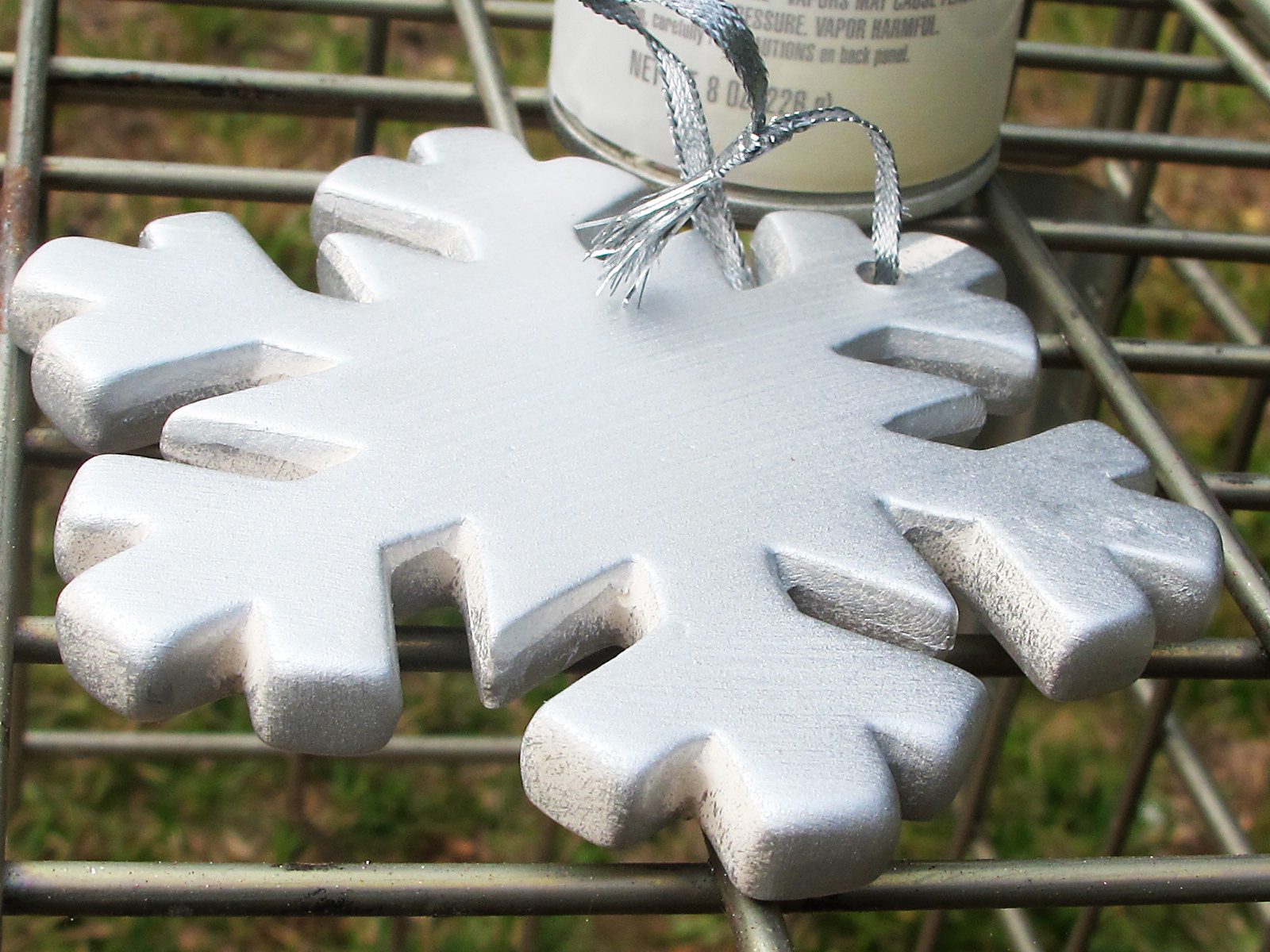 Drying white snowflake resin ornament.