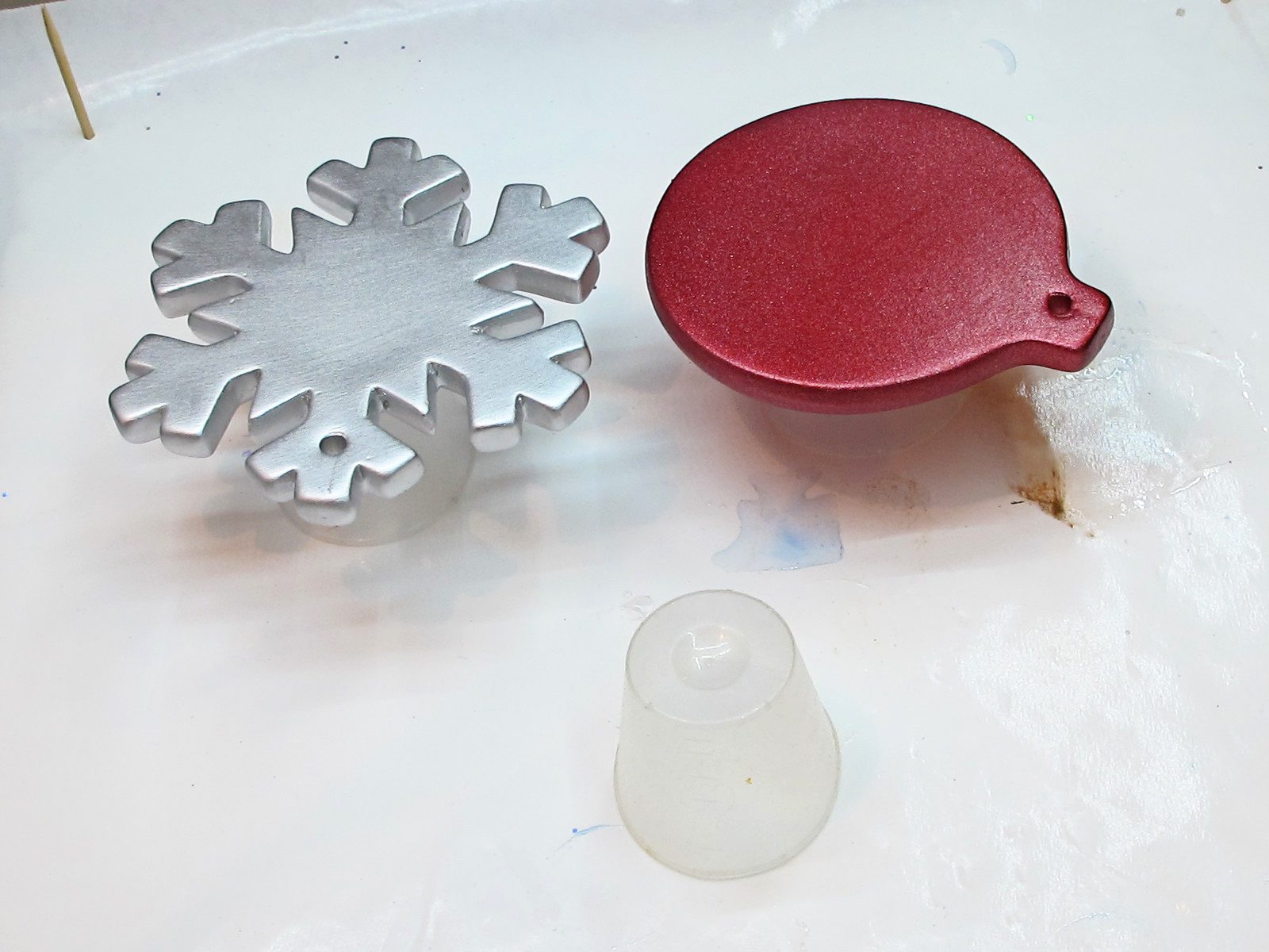 A drying snowflake and red circle Christmas ornament.