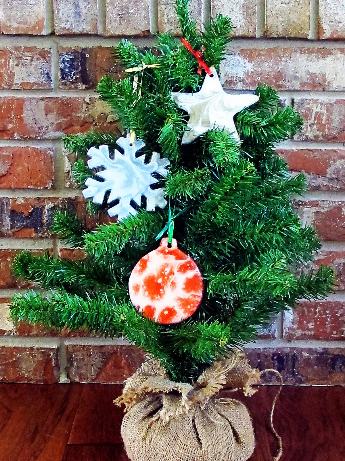 Three resin ornaments on miniature Christmas tree.