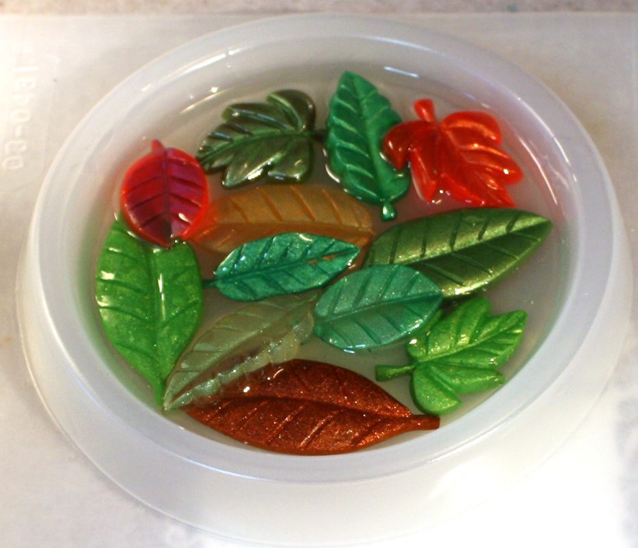 Coaster mold filled with colorful resin leaves