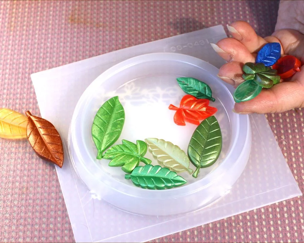 Placing resin leaves into a silicone mold.