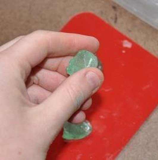 hand holding dried piece of sea glass resin