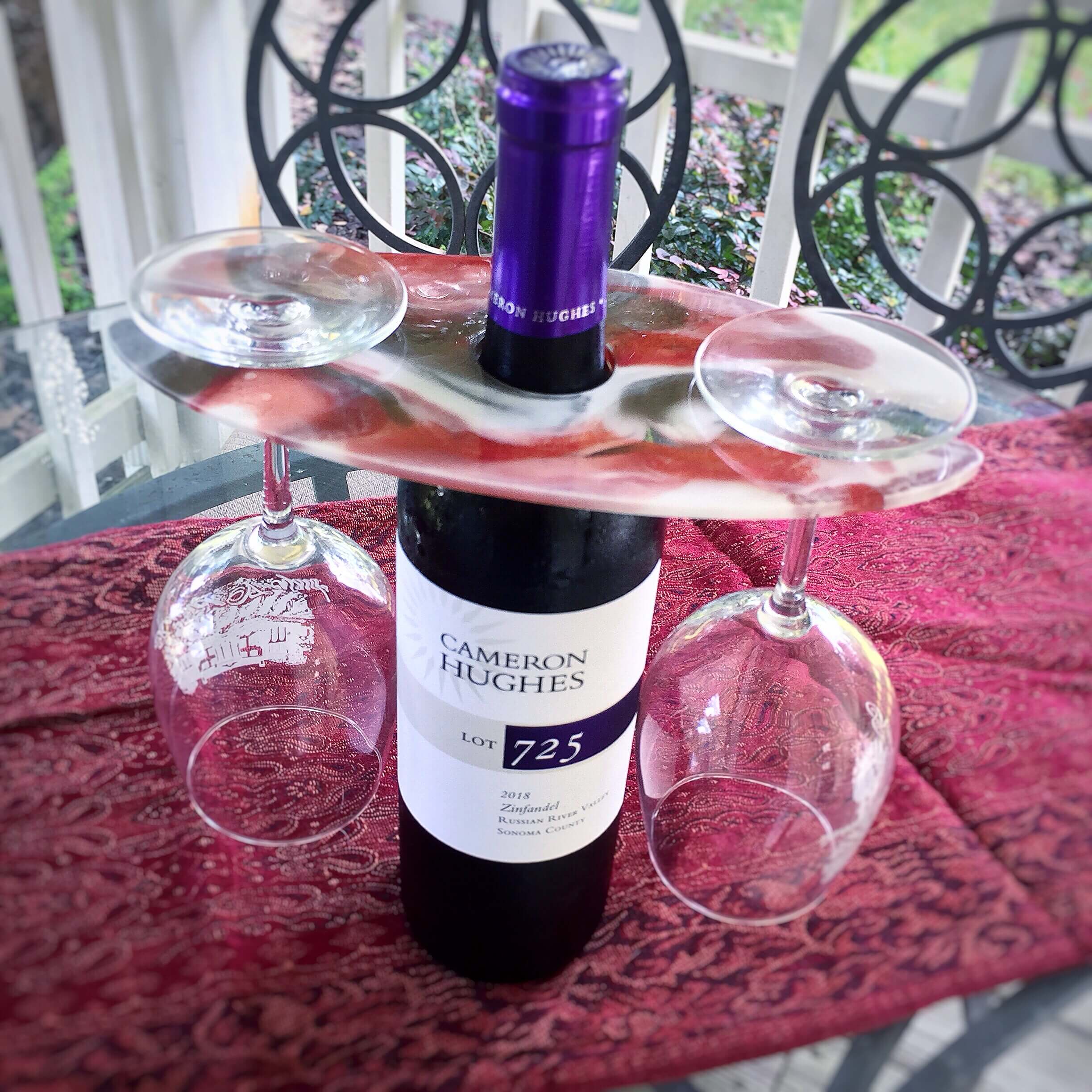 wine bottle with resin wine caddy and glasses