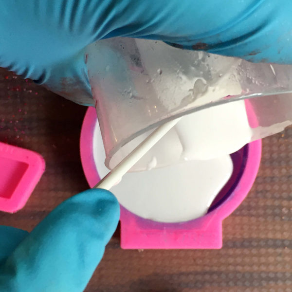 pouring colored resin into a silicone mold