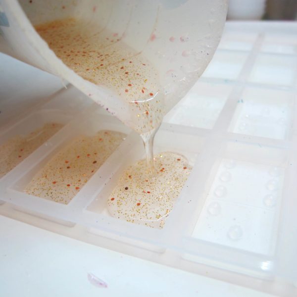 pouring epoxy into a domino mold