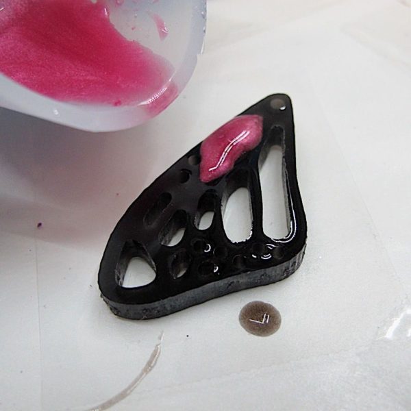 adding pink resin to DIY butterfly wing earrings