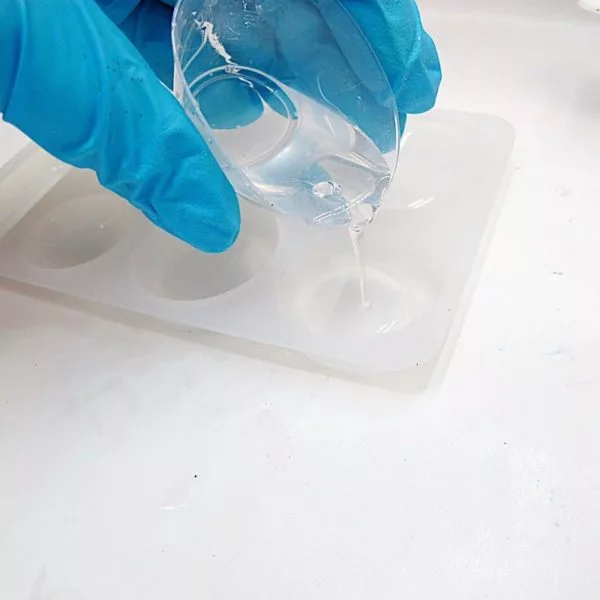 adding clear epoxy to a mold