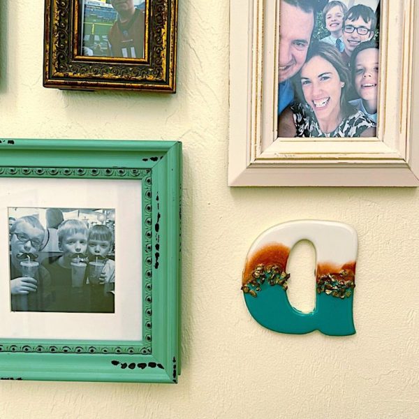 resin letter on photo gallery wall