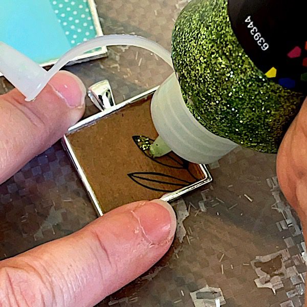 adding glue glitter to paper