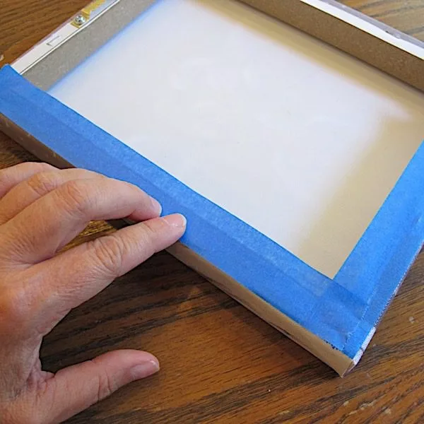 adding tape to canvas