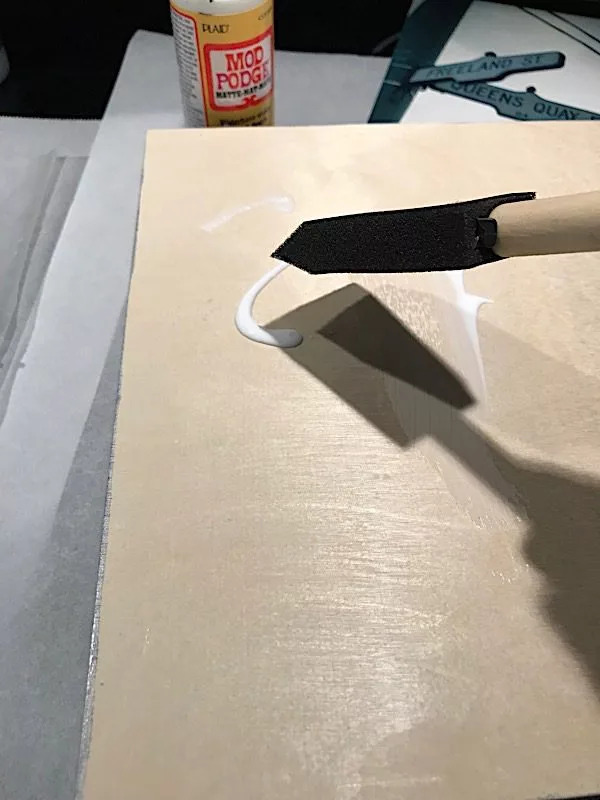 adding glue to a cradled wood board